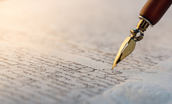 Fountain pen on an antique handwritten letter. Vintage nib pen and handwritten english cursive style font copperplate, spencerian. Old history background. Retro style.