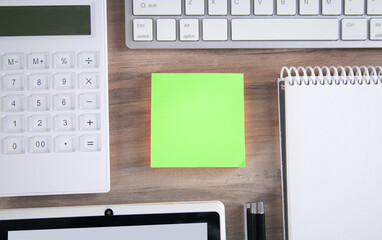 Sticky note with a keyboard and business objects.