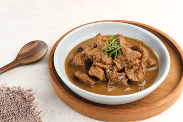 Daging Kelem is a traditional food from Central Java, Indonesia, made from beef, coconut milk and spices. It tastes sweet and savory. Served in bowl, close up.
