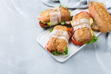 Fresh rye bread sandwich with ham, lettuce and tomato