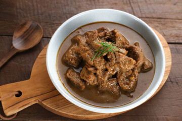 Daging Kelem is a traditional food from Central Java, Indonesia, made from beef, coconut milk and spices. It tastes sweet and savory. Served in bowl, close up.
