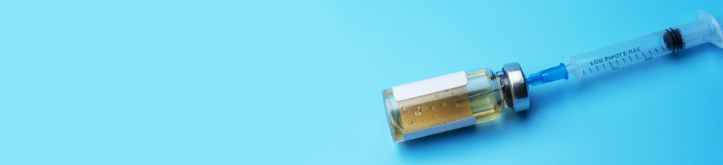 Medical bottle with syringe on blue background. Place under the text.