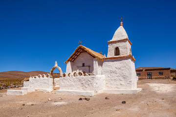 White church (Iglesia de Caraguano) under deep blue sky on the high altitude plateau of the Andes...