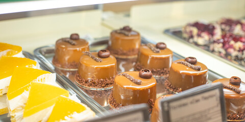 Cakes in the supermarket. Sweets under glass. Sweets buffet