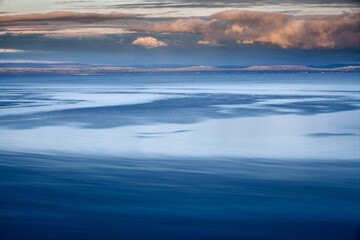 Abstract impression of a landscape with sea, mountains and clouds along the Porsanger fjord, Finnmark, Norway