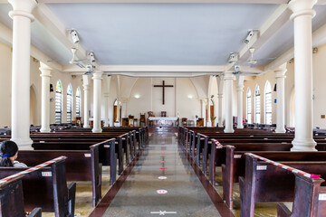 Main nave and altar of St. Paul's Anglican Cathedral, Victoria, Seychelles, inside view of the church with stained glass windows.