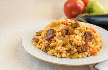 Traditional Turkish pilaf from bulgur, vegetables and eggplant on the table