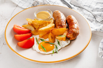 Traditional british cuisine: sausages with potatoes and eggs