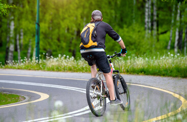 Fototapeta premium Cyclist ride on the bike path in the city Park 