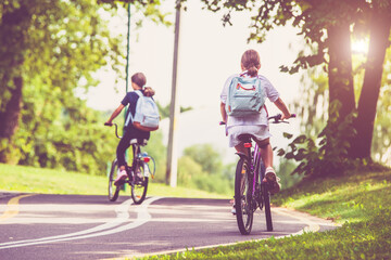 Fototapeta premium Cyclists ride on the bike path in the city Park 