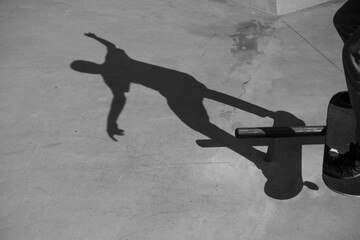 A skateboarder doing a boardslide in black and white.