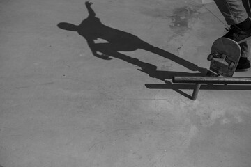 A skateboarder doing a boardslide in black and white.