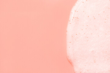Fototapeta premium The texture of a scrub or shower gel on a pink background.