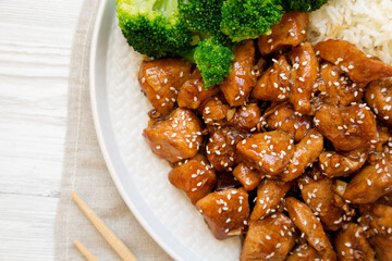 Homemade Teriyaki Chicken with Rice and Broccoli on a plate on a white wooden background, top view. Flat lay, overhead, from above.