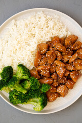 Homemade Teriyaki Chicken with Rice and Broccoli on a plate on a gray background, top view. Flat lay, overhead, from above.