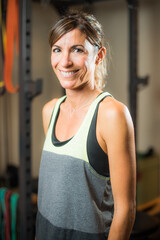 Fototapeta na wymiar Portrait of athlete woman in gym looking at camera