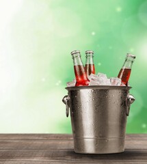 Bottles of cold and fresh beer with ice in a bucket