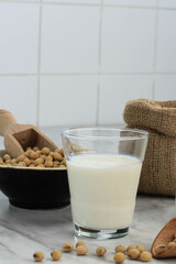 Soy Milk and Grains on a Wooden Table and Rustic Kitchen Background. Alternative Milk Concept. Front View