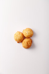 Toasted coconut cake on white background. Top view, flatlay. Nobody. Soft lighting