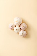 Garlic on beige pastel background. Topview, flatlay. Vegetable 