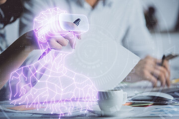 Double exposure of AR glasses drawing over people taking notes background. Concept of VR