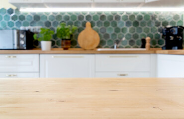 blurred kitchen interior and wooden desk space home background