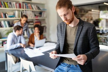 Business partners sharing ideas and planning work at meeting in office