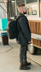 Portrait of man choosing fast food in food truck in the street. Meal, food industry and streetfood concept.