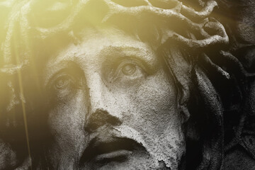 Passion of Jesus Christ, fragment of an ancient stone statue. Close up.