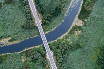 The road in the village crosses the river, shot from above