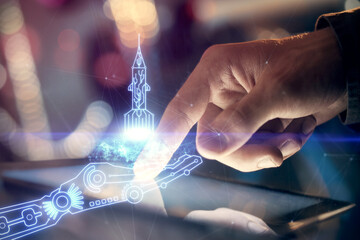 Double exposure of man's hands holding and using a mobile device and creative hologram drawing.