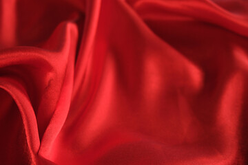 abstract texture of draped red velvet background. eautiful textile backdrop. Close-up. Top view