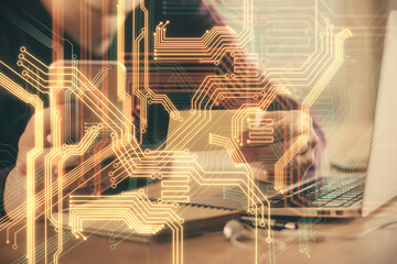 Double exposure of man's hands holding and using a digital device and tech theme hologram drawing. Technology concept.