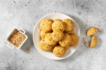 Homemade Norwegian butter cookies with almonds on a light culinary background. Traditional Scandinavian pastries top view.