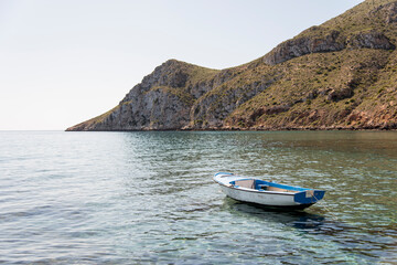 Fototapeta na wymiar Small old boat anchored near the beach