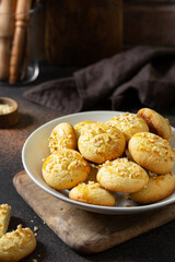 Homemade Norwegian butter cookies with almonds in a plate on the cooking table. Traditional Scandinavian pastries close-up. Dark background