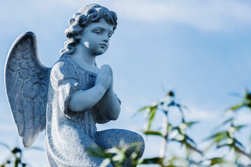 Little angel against blue sky as symbol of guards for child. Copy space.