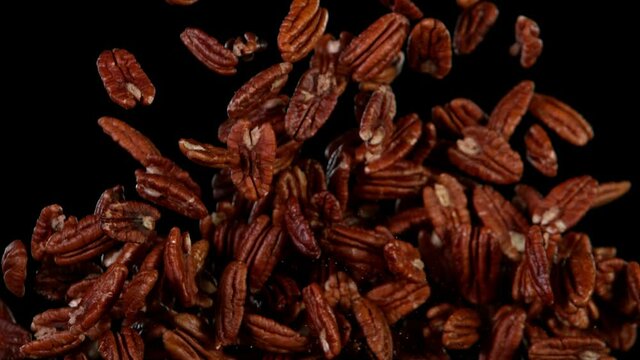 Super Slow Motion Shot of Flying Natural Pecan Nuts. Filmed on High Speed Cinematic camera at 1000 fps.
