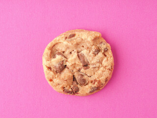 Sweet chocolate cookie on a pink background