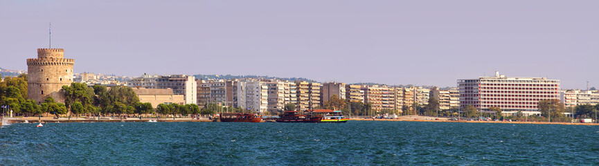 Fototapeta na wymiar Panoramic view of white tower and seaside promenade in the evening in Thessaloniki, Greece