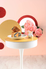 Mooncake on Light Pink Background with Pink Flower. Concept Moon Cake on Mid Autumn Festival. Mooncake Popular as Kue Bulan.