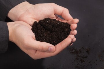 hands holding dirt