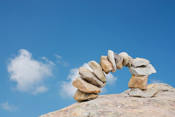 Arch of stones with blue sky background and clouds
