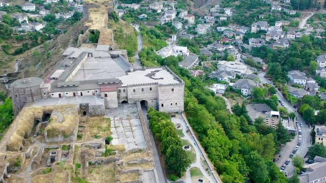 Castle of Gjirokastra and city center. Aerial view of ancient fortress Albania