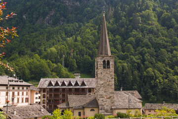 Fototapeta na wymiar Summer view of Alagna town situated in Piedmont , Italy. Town famous for snow sport activities , rafting , and tracking . Church of San Giovanni Batista