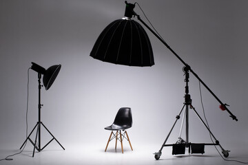 Photo studio with lighting equipment. light scheme and chair. The concept of selection and casting....