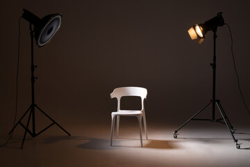 Photo studio with lighting equipment. light scheme and chair. The concept of selection and casting....