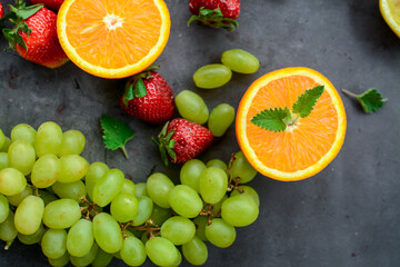 Various fruits and vegetables on dark background in the kitchen