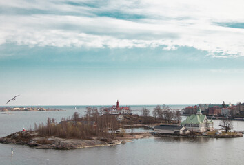 island, seagull and buildings on the high seas