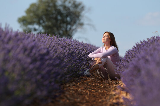 Woman resting sitting in a lavender field